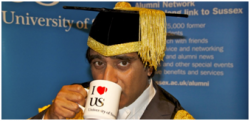 Picture of Sanjeev Bhaskar drinking a mug of tea (or maybe coffee) at Graduation