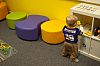 A little boy choosing a toy at the WORD Lab in the waiting room.