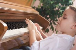 boy playing paino boy playing paino