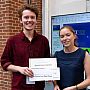Meirin is presented with his certificate and cheque for his Research Poster award
