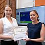 Noora receives her certificate and cheque for winning first place in the 3MT competition