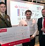 Jame Bradbury proudly presents the teams donation to the Help for Heroes charity