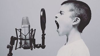 boy shouting into microphone