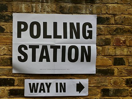 A photo of a sign pointing to a polling station