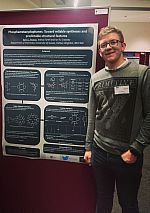 Kyle with his poster at the Dalton 2018 meeting