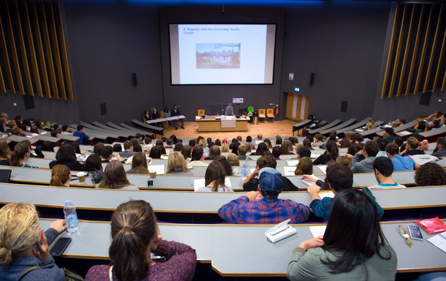 Students listening to a presentation in a lecture theatre