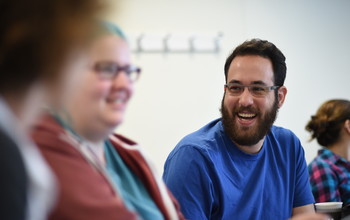 students chatting in a classroom setting