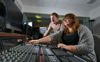 An academic using sound system equipment at the University of Sussex