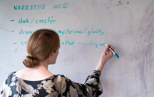 Seminar leader writing on a white board in a seminar at the University of Sussex