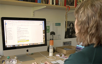 Academic on a computer at the University of Sussex