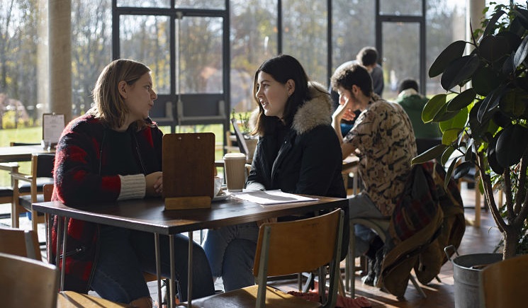 Students talking in a cafe on campus
