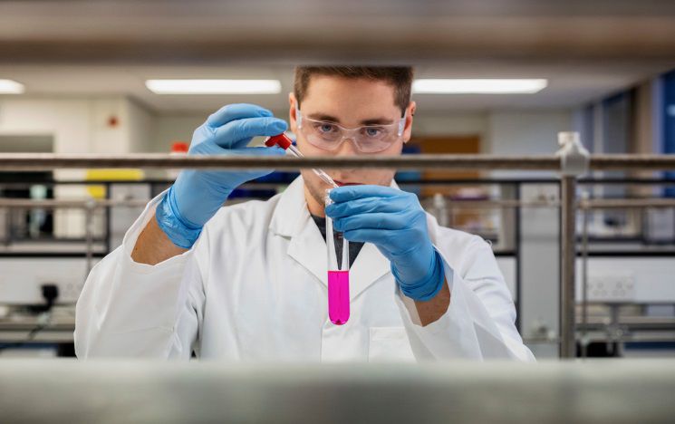 Icon: a student inspecting a test tube