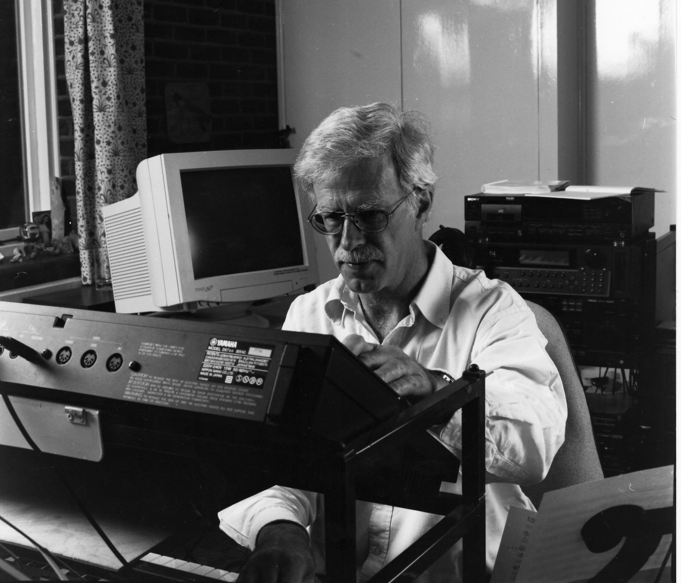 Professor Jonathan Harvey working in his office, sat at a keyboard