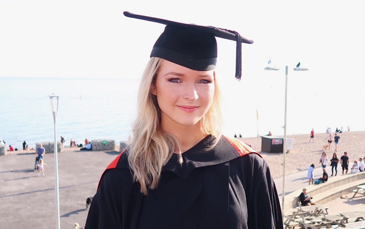 Biochemistry student Lois Barber in graduation gown smiling to camera