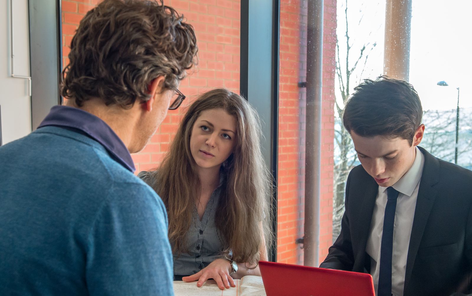 A male and female law student in discussion with a client