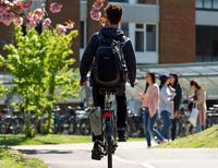 Man cycling on campus