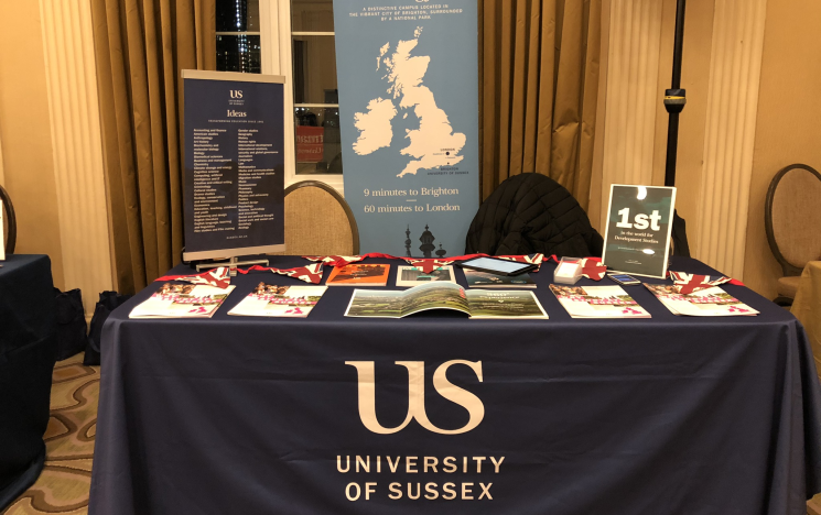 Blue University of Sussex stall inside a building