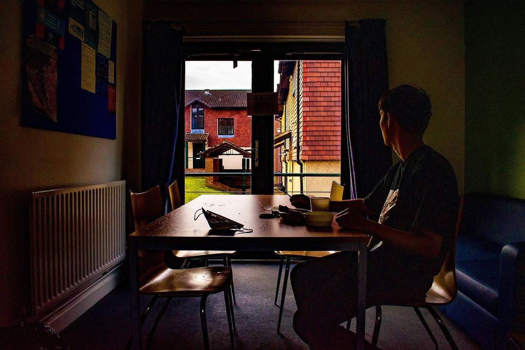 A student looks out a window in University accommodation