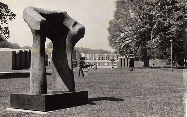 
            Black and white photo of a bronze sculpture of a torso by Henry Moore, taken by Robert Cahn.