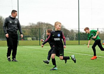 Children playing football at the University