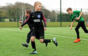 Children playing football at the University