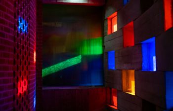 Light coming through the coloured windows of the Meeting House