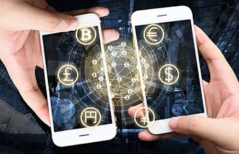 Two smartphones exchanging digital currency