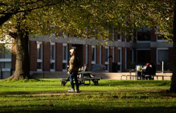 Person walking across Sussex campus