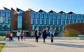 people walking in front of the Business School