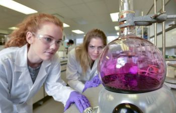 Two students conducting a chemistry experiment in the lab