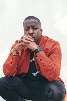 Portrait image of Jamal Edwards crouching