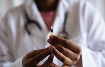 A doctor holding an injection in her hands