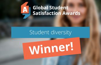 A banner detailing the University's global award win in student diversity is laid over a faded out image of a female student wearing a coat