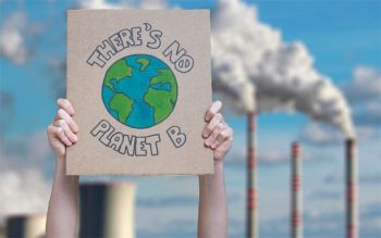 Two hands raised holding a cardboard with drawing of Earth and the message 