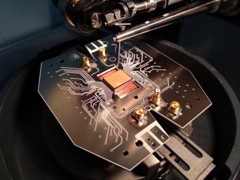 An overhead view of a circuit board in the quantum computer