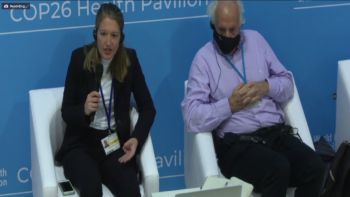 A man and woman on stage at COP26
