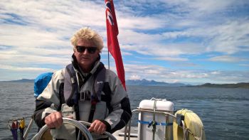 Professor Bacon helming his boat Peverall off the west coast of Scotland