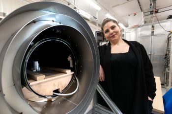 Lead research author Aikaterini Gialopsou with magnetic shield where participant brain signal measurements are taken