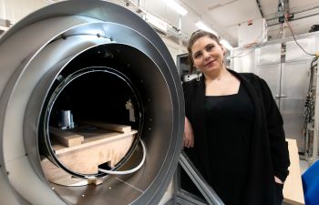 Lead research author Aikaterini Gialopsou with magnetic shield where participant brain signal measurements are taken