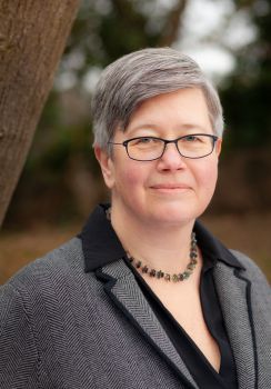 Head and shoulders photo of Prof Sasha Roseneil who has short grey hair, glasses and is wearing a grey suit jacket