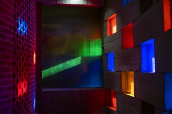 Shafts of light coming through coloured blocks in the Meeting House