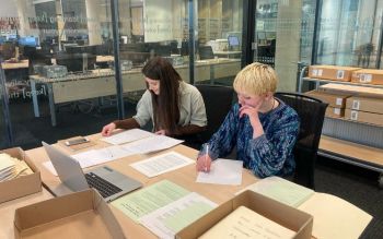 Two young women doing research at The Keep