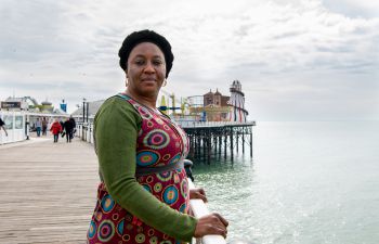 Awa Gaye Jeng, Article 26 Scholar, standing on the Palace Pier