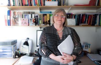 Portrait photograph of Professor Heather Keating in her office.
