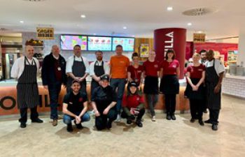 Eat Central staff team posing in front of a counter. The word 