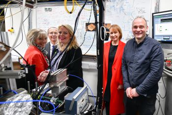 A photo of Cllr Ruth de Mierre, Prof Keith Jones, Mims Davies MP, Kathryn Hall & Prof Winfried Hensinger in the quantum computer laboratory