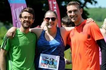 Image of three people outside smiling