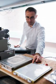 Dr Mark Bason with an electric vehicle battery in the Quantum Systems and Devices lab