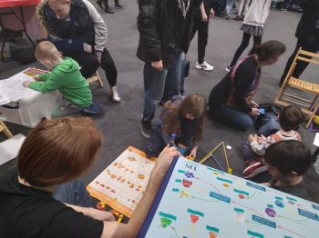 Children playing with Lego pieces and printed colouring books at the EPP stand at the Festival of Tomorrow