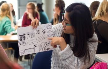 female showing poster in development class